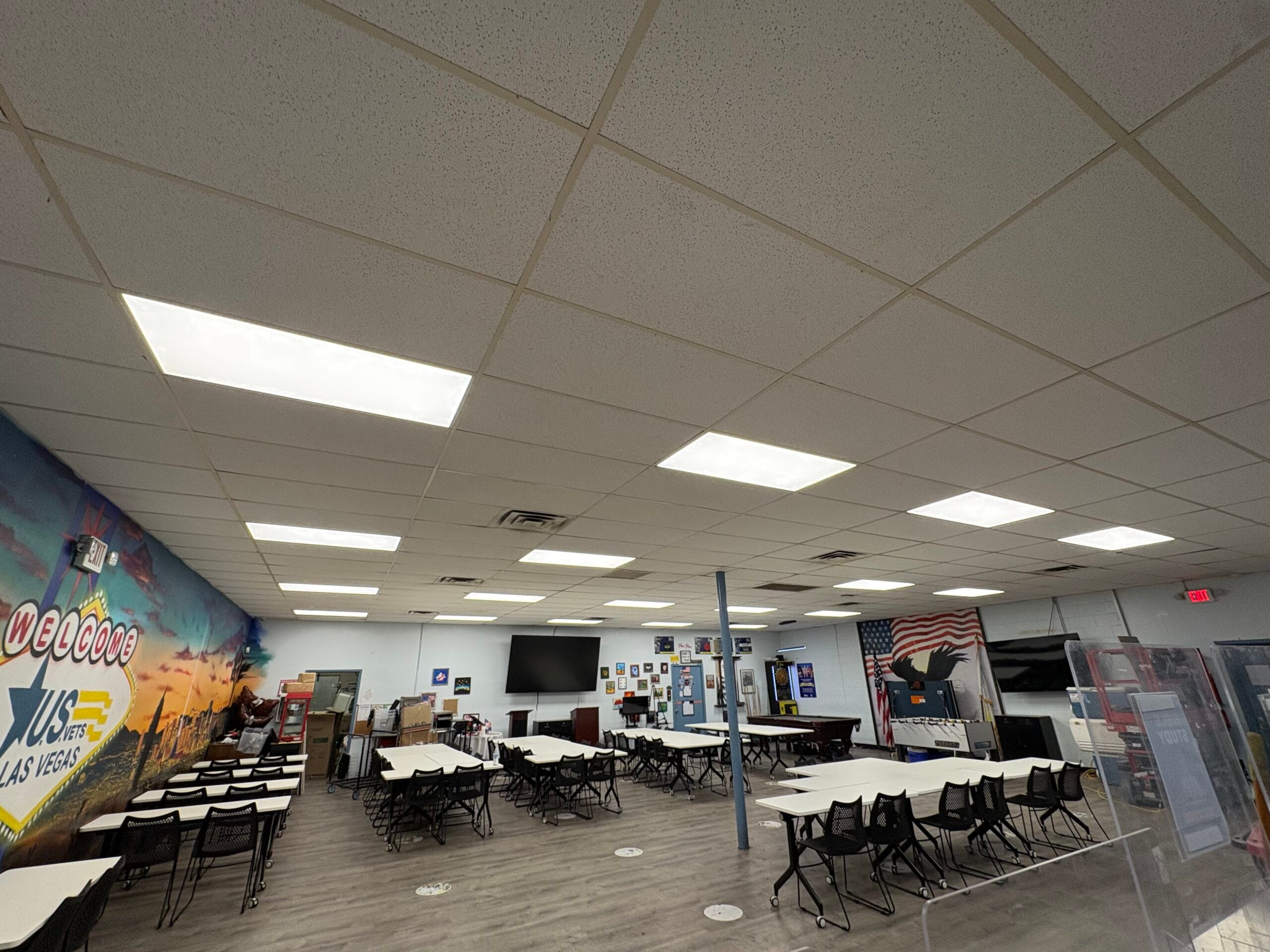 Modern commercial office space with LED ceiling panel lighting networking infrastructure and collaborative work areas